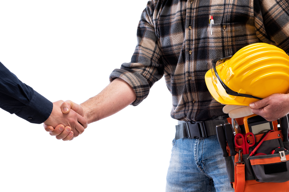Close-up,Of,A,Handshake,Of,The,Electrician,Carpenter,Holding,Helmet