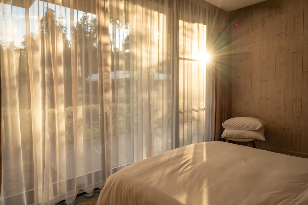 Warm,Sunlight,Is,Streaming,Through,Sheer,Curtains,Into,A,Cozy
